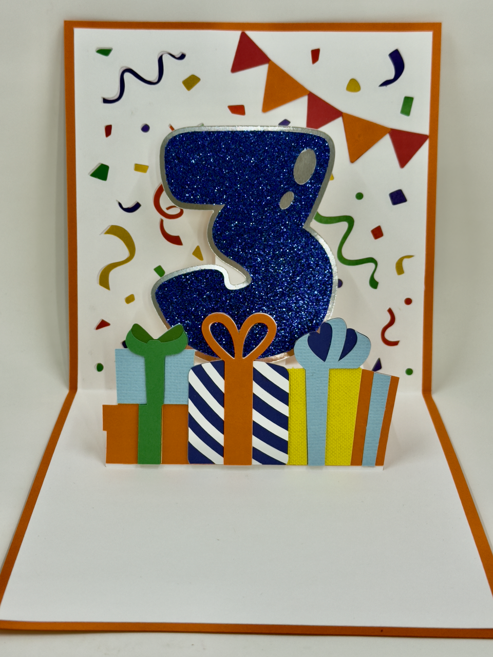 A colorful birthday card featuring a cartoon dump truck with balloons and birthday decorations.
